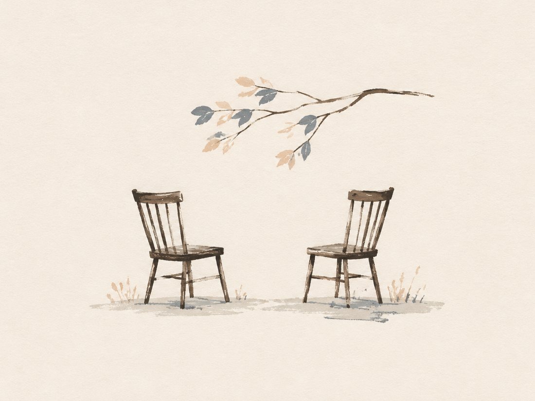 Two hand-painted wooden chairs facing one another beneath a branch